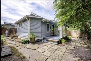a small white house with a porch at Peaceful Private Cottage, Walk to Park & 5 Mins to Downtown in Nashville