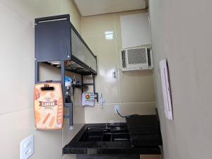 a small room with a sink and a microwave at Fully equipped apartment - Jardim Boa Vista in Caruaru +10 photos