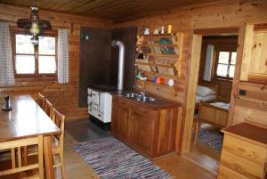 a kitchen with a stove in a log cabin at Fröschlhütte in Oberpirkach