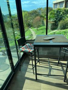 a table and chair on a balcony with a view at Cabañas Ecoturísticas Villa Beatrice in San Francisco