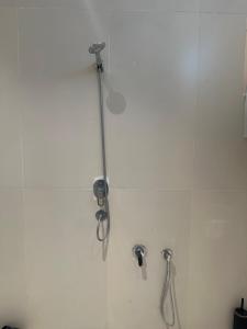 a shower stall with a pair of scissors on a wall at شقة رقم 1 in An Najaf