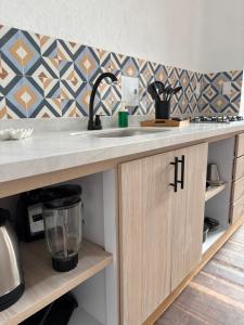 a kitchen with a sink and a counter top at Casona El Nacional in San Gil