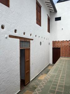 a white house with wooden doors and a courtyard at Casona El Nacional in San Gil
