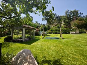 a playground in a park with a gazebo at Quinta do Botas in Moimenta