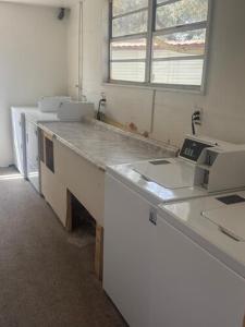 a kitchen with two sinks and a counter in a room at Star Motel in Tampa