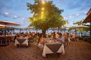 a group of people sitting at tables in a restaurant at Bella Vista 3F 3 bdr beach club view in Los Suenos in Herradura