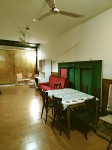 a living room with a table and chairs and a couch at Posada Familiar ELDORADO in Eldorado