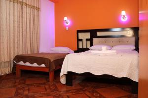 a bedroom with two beds in a room at Gran Mansion Dorada in Tacna