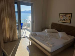 a bedroom with a bed with a view of the ocean at Hotel Divers in Vlorë +107 photos