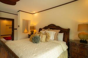 a bedroom with a large bed and two lamps at Casa Plazoleta 4 bdr private pool in Los Suenos in Herradura +31 photos