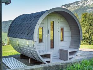 a circular dome house with a bench in front at Villa mit Seeblick in Amden