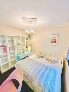 a bedroom with a bed and a chair at Winter CBD retreat,Fireplace,Free secure parking, Balcony, NETFLIX, FREE WIFI, Walk to Rundle St, UniAdelaide, Casino, Pubs, Cafes in Adelaide