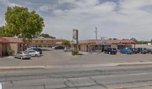 a parking lot with cars parked in front of a store at Crystal Motel in Red Bluff +9 photos