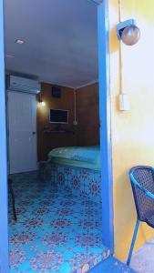 a room with a bed in the corner of a room at Banpu Beach Ao Lung Dam,Koh Samet in Ao Phutsa
