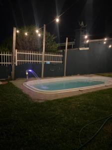 a hot tub in a yard at night at Luciene in Xangri-lá +7 photos