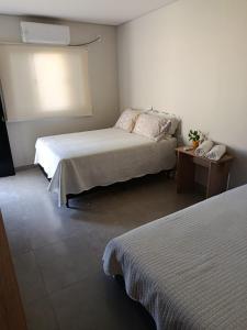 a hotel room with two beds and a window at Espaço Real in Manhã