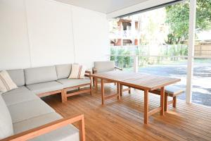 a living room with a couch and a table at Soluna House in Byron Bay