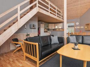 a living room with a couch and a table at 8 person holiday home in Læsø in Læsø