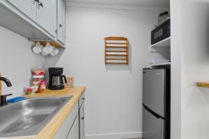 a kitchen with a sink and a refrigerator at The Briarcliff Suite studio in Athens