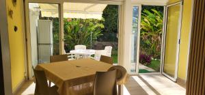 a dining room with a table and chairs on a patio at Escale caraibe in Le Gosier