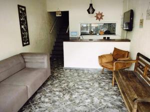 a living room with a couch and a table at Hostal B&C in Angra dos Reis
