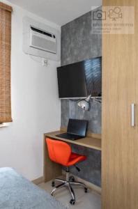 a room with a desk with a red chair and a laptop at Studio Centro - 7 Copas in Rio de Janeiro