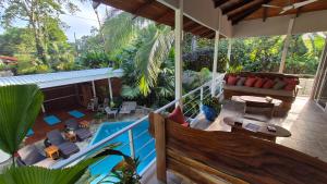 an outdoor patio with a swimming pool and a house at Sanctuary Puerto Viejo in Cocles