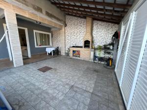 an empty room with a fireplace in a house at Búzios Family House in Búzios