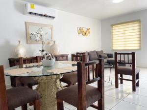 a living room with a dining room table and chairs at Casa Coralina in San Carlos