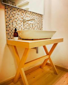 a wooden table with a sink in a bathroom at Lovingly Restored Half-Timbered House From 1684 in Großschönau
