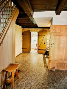 a room with a staircase and a wooden bench at Lovingly Restored Half-Timbered House From 1684 in Großschönau +26 photos