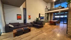 a living room with a couch and a table at Villa #40, Ambassadori Kachreti Golf Resort in Kachretʼi