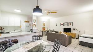 a kitchen and living room with a couch and a table at Trinity Beach Pacific in Trinity Beach