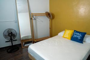 a bedroom with a bed with a mirror and a fan at Rincón pochutleco in San Pedro Pochutla