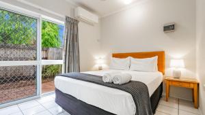 a bedroom with a bed with two towels on it at Trinity Beach Pacific in Trinity Beach +51 photos