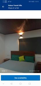 a bedroom with a bed with two green and yellow pillows at Solace Transit Villa in Katunayaka