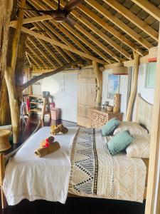 a bedroom with two beds with towels on them at Raiatea Treelodge in Taoru
