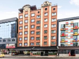 a large brick building with a clock on top of it at Hotel Splendor by Friends Company in Bogotá