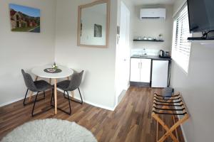 a small kitchen and dining room with a table and chairs at Clyde on Naylor in Clyde