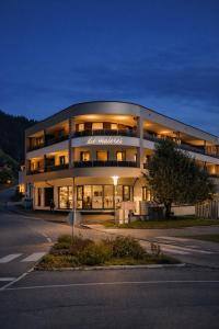 a large building with lights on the side of a street at Die Malerei Penthouse by Da Alois in Gröbming