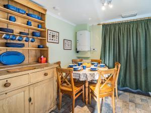 a kitchen with a table and chairs in a room at 2 Fairview Terrace Ambleside in Ambleside