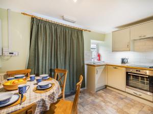 a kitchen and dining room with a table and chairs at 2 Fairview Terrace Ambleside in Ambleside