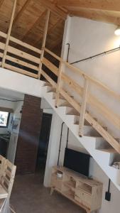 a staircase in a room with a couch and a table at Los Almendros in Nueva Atlantis