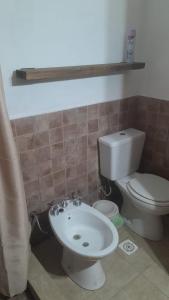 a bathroom with a toilet and a sink at Los Almendros in Nueva Atlantis +3 photos