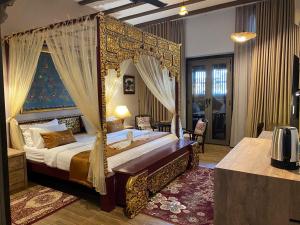 a bedroom with a canopy bed in a room at ke-lan-tan House in George Town