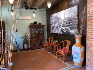 a room with a table and two chairs and a picture at ke-lan-tan House in George Town
