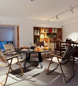 a living room with a table and chairs at Panorama Peaks Lodge-Free pickup-Sunrise-Close to the Middle Gate Ticket Office of the Zhangjiajie Foreset Park in Zhangjiajie
