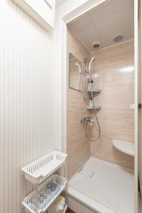 a bathroom with a shower and a sink at Guesthouse YOURS in Osaka
