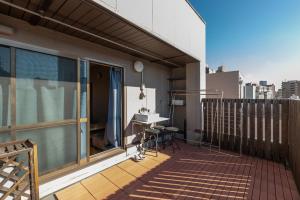 a balcony with a desk on a building at Guesthouse YOURS in Osaka
