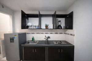 a kitchen with a sink and a refrigerator at Inmosolaris in Cali